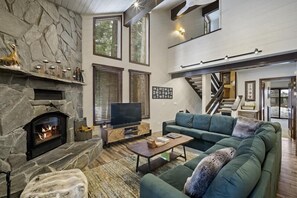 Huge sectional sofa nestled up to the fireplace