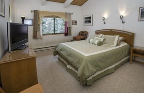 Large master bedroom with TV and large window