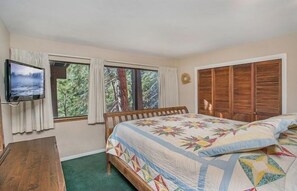 Bedroom comfort with large windows and TV