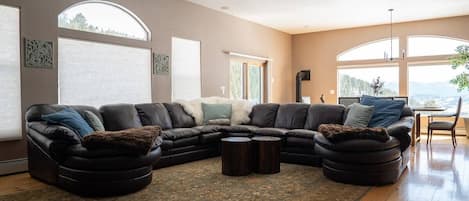 Our wonderfully spacious living room! Huge leather sofa & tons of natural light
