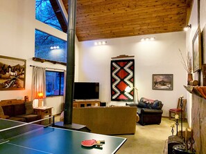 Samsung Smart Tv, pingpong table on a pool table. Reading lamp furnace, candles.