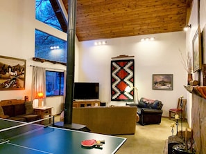 Samsung Smart Tv, pingpong table on a pool table. Reading lamp furnace, candles.