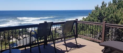 private access deck off primary bedroom w 2 lounge chairs w cushions. 