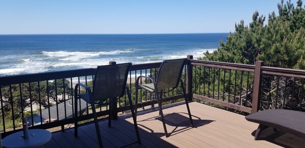 private access deck off primary bedroom w 2 lounge chairs w cushions. 