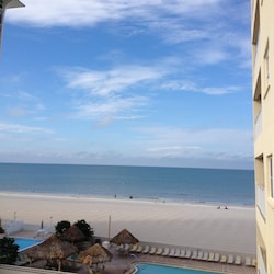 View from balcony of pool, Jacuzzi, beach, & Gulf