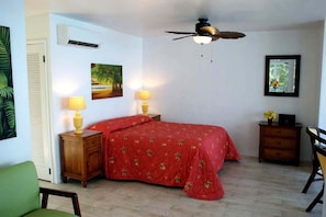 Sleeping area with air conditioning and overhead fan.