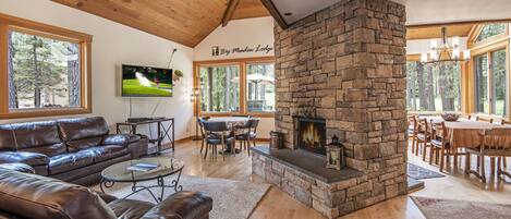 Open living and dining area with wood-burning fireplace 