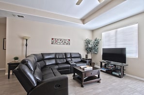 Living area with reclining sectional and 64" TV