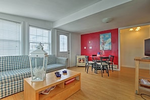 Hardwood floors and several windows highlight the interior.