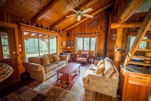 Living room light and airy, great views of the forest.