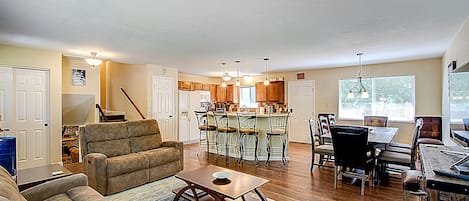 Open concept flow throughout kitchen, living area, and dining.