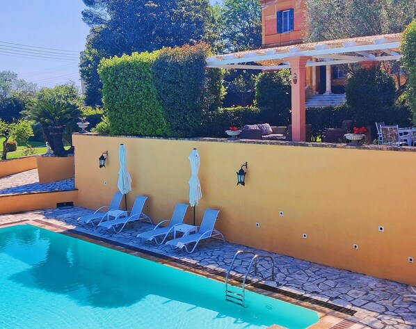 private terrace with 4 private sunbeds for the house - communal swimming pool.