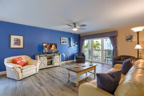 Spacious and Updated Living Room with Leather Sleeper Sofa and Flat Screen Cable TV