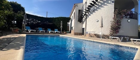 An aspect of the swimming pool and patio from the deep end. 2 metres.