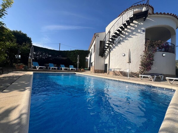 An aspect of the swimming pool and patio from the deep end. 2 metres.