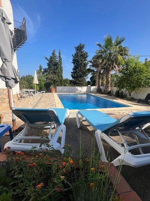 An aspect of the pool from the shallow end and patio