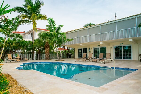 Brand-new 16'x35' swimming pool with screened in porch and BBQ in the background