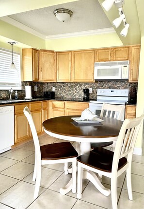 The kitchen is stocked with the essentials like toaster, dishes, utensils, soap