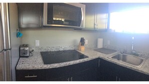 Fully functional kitchen. The sink has garbage disposal