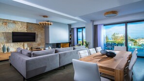 Living Room : Elegant living room with a large sectional sofa and outdoor views.