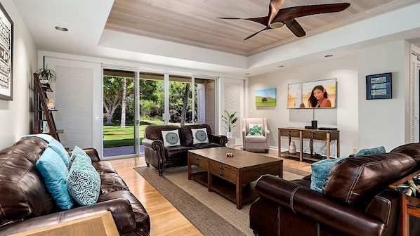 Living Area with Comfortable Sofas, Ceiling Fan, and Smart TV