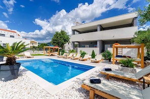 House in front , swimming pool and garden area 