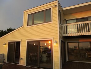 View on patio doors of our home with reflection of the bay and our pier.