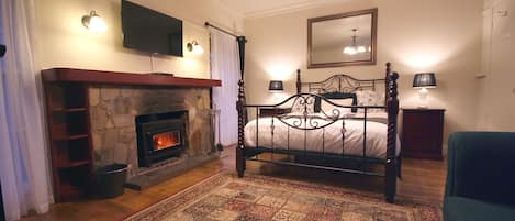 Queen-sized bed and wood fireplace.