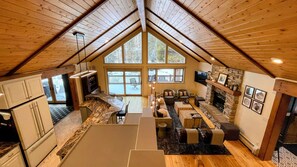 View from top of staircase, highlights the open floor plan and luxury furnishes