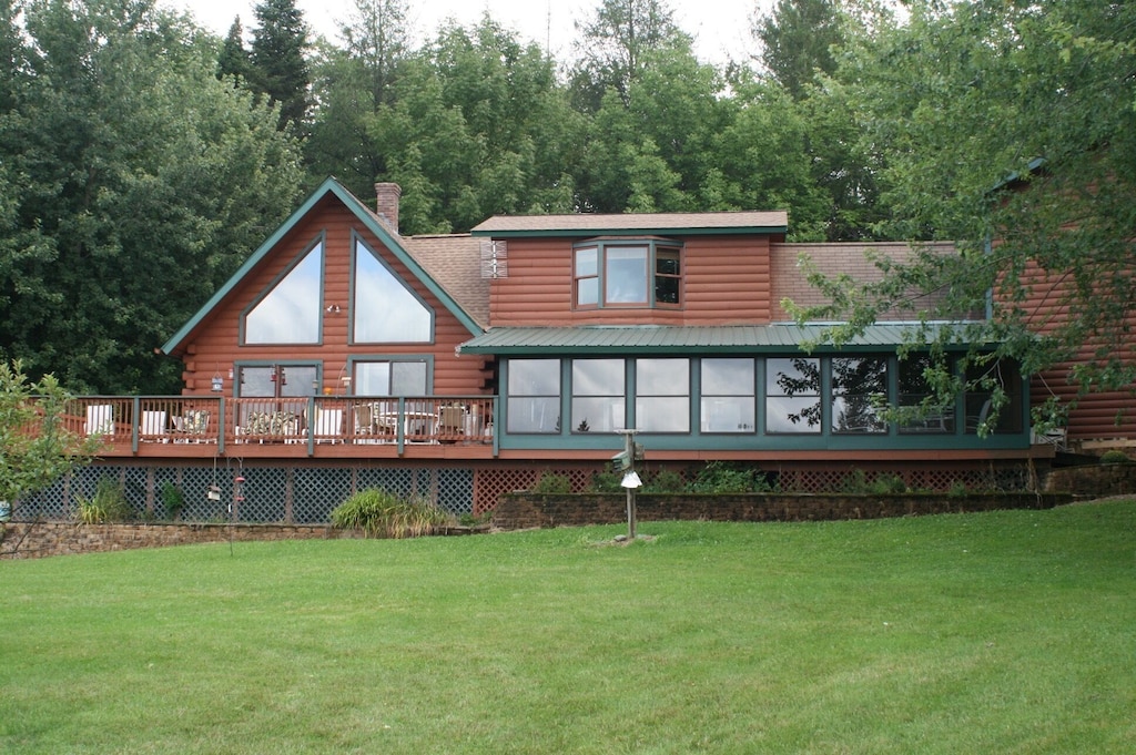 A log themed Vermont cabin rental is surrounded by dense woods