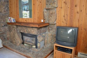 StayWinterPark Beaver Village Condos TV and fireplace in living room unit 834