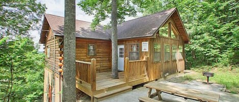 Front porch has two chairs, picnic table on the patio with charcoal grill~