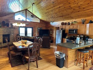 Open floor plan with dining room table and bar stools~