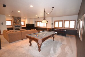 Game room with pool table and foosball table.
