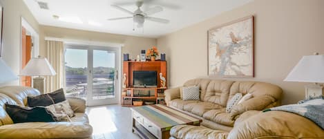 Living room with leather couch, love seat and cozy chair, 50" flat screen HDTV, DVD and stereo/CD player.