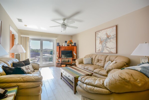 Living room with leather couch, love seat and cozy chair, 50" flat screen HDTV, DVD and stereo/CD player.