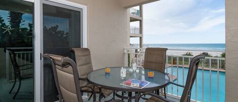 Patio with Seating for 4 Overlooking the Pool and Beach at New Smyrna Beach Vacation Rentals