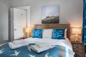 Ground floor: Bedroom one with a 5' king-size bed