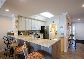 Updated kitchen includes a new full size fridge and electric range.