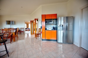 Large double door fridge/freezer inside the huge kitchen.  