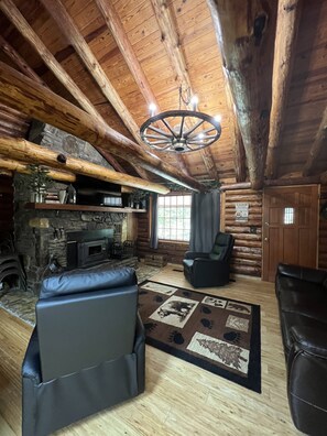 View of the openness and the beautiful authentic cabin wooden beams. 