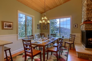 Main floor dining room with mountain views through the trees