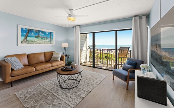 Step into a cozy living space filled with sunlight and a stunning view