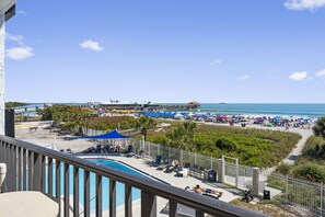 Gorgeous rooftop patio with lounge chairs, ocean views, and relaxation spots.