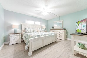 Rest in this serene master bedroom with king size bed, soothing colors and a plush bed
