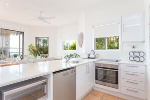 Galley kitchen overlooking Moreton Bay as you cook