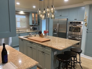 Gourmet kitchen with double oven, gas range, two sinks, 2 fridges & dishwasher.