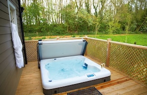 Decked area with garden furniture and hot tub