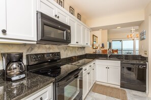 Kitchen custom cabinetry , granite surfaces, marble backsplash and flooring