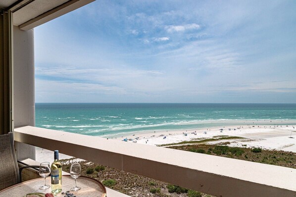Incredible views of the Gulf of Mexico from the living room open-air balcony. Stacked sliders open extra wide!